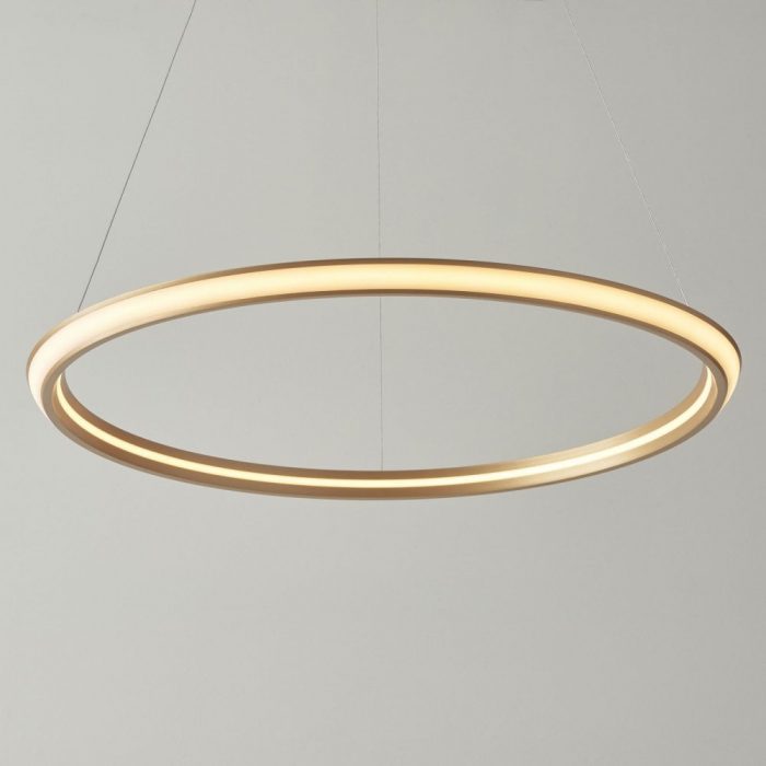 A gold, illuminated circular pendant light attached to three, long wires.