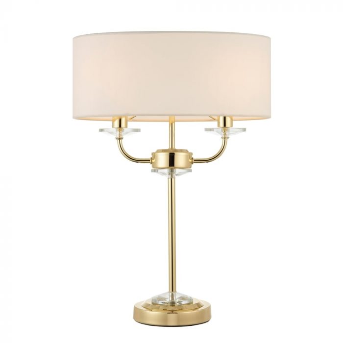 A brass table lamp with a beige lampshade.