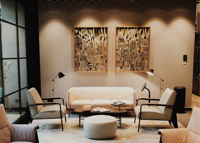 Contemporary cream living room area with art and floor lamps