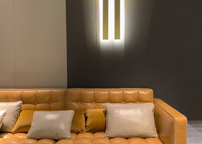 Modern mustard sofa, stylishly illuminated by long panel wall lights