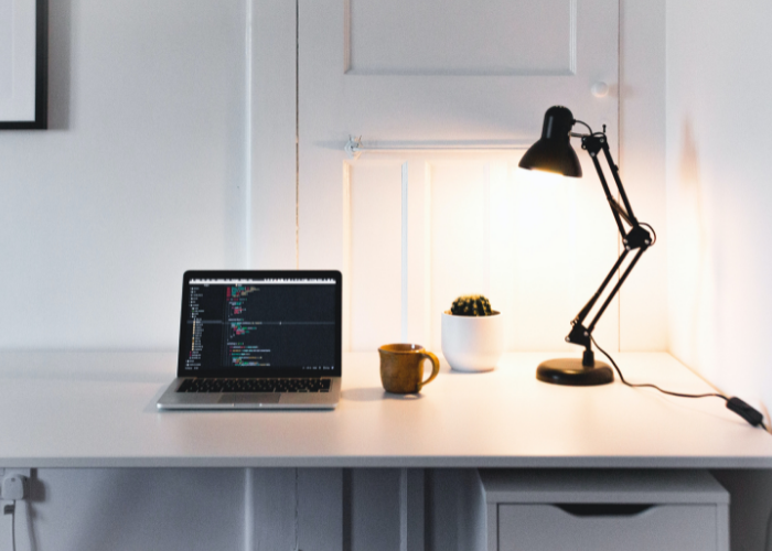 Home desk with laptop and adjustable table lamp